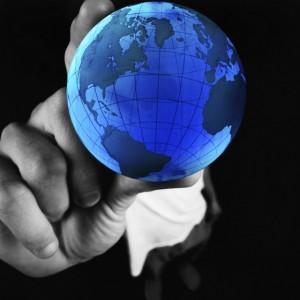 Hand holding globe. Prove Kinship can perform wordwide due diligence.